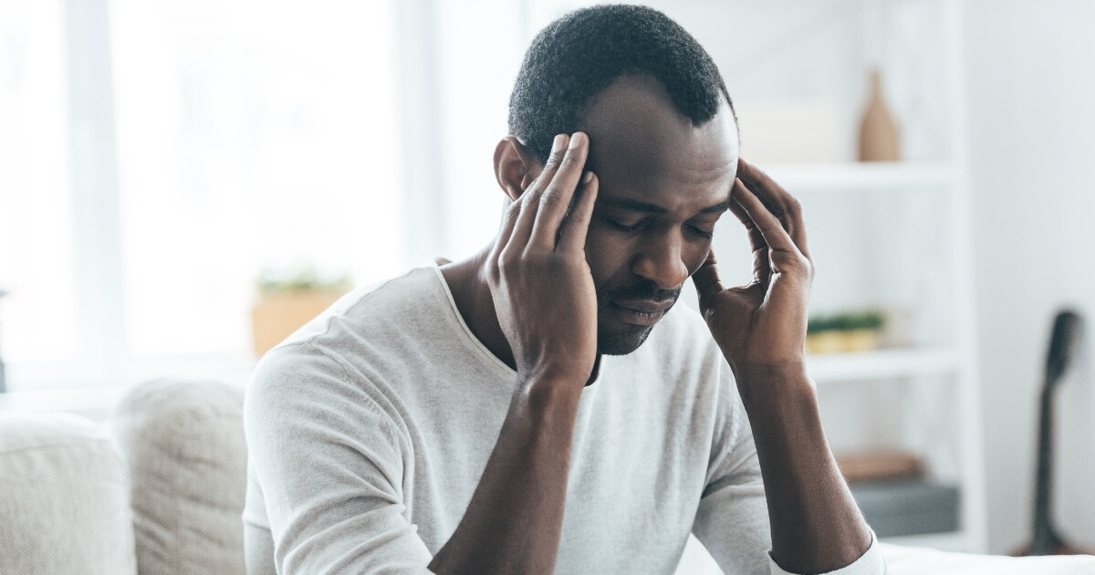 Person holding their head in pain.