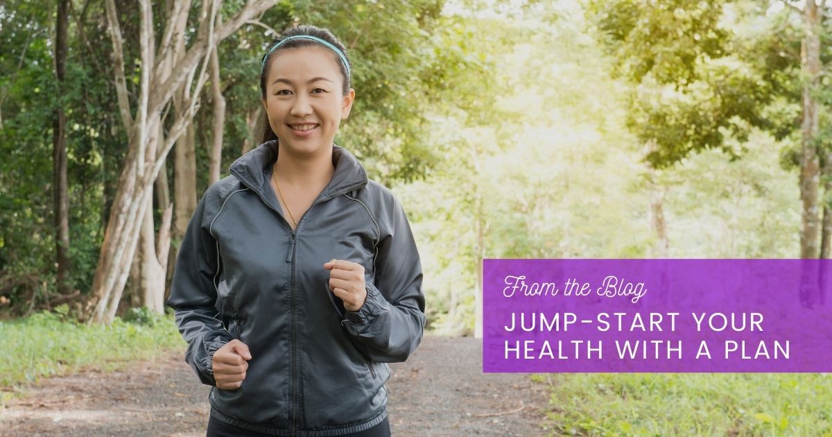 Woman meeting with health coach and smiling while looking over wellness plan.
