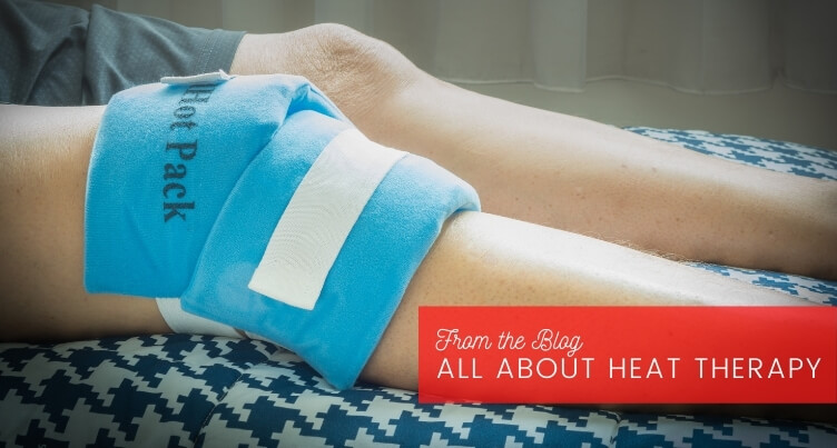 Woman using heating pad on back while relaxing on couch.