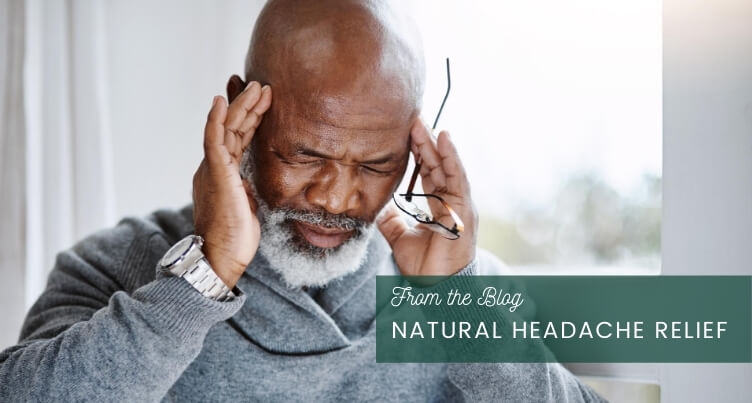 Man gently massaging her temples to relieve headache.