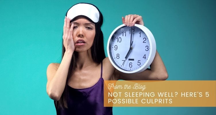 Woman lying awake in bed looking tired and frustrated.