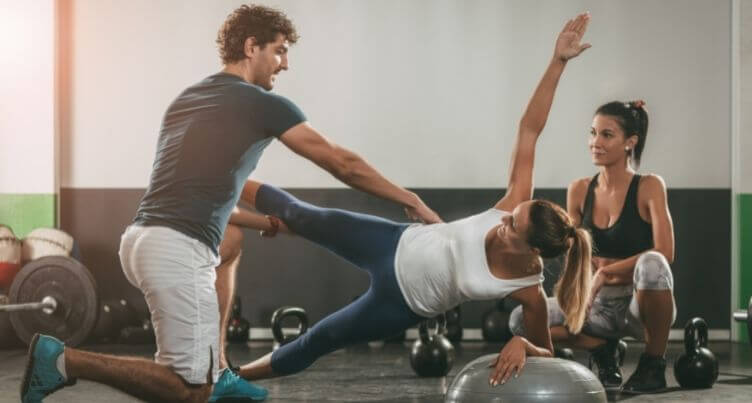 Woman stretching her sore arm muscles after a workout. chiropractic therapy for headaches
